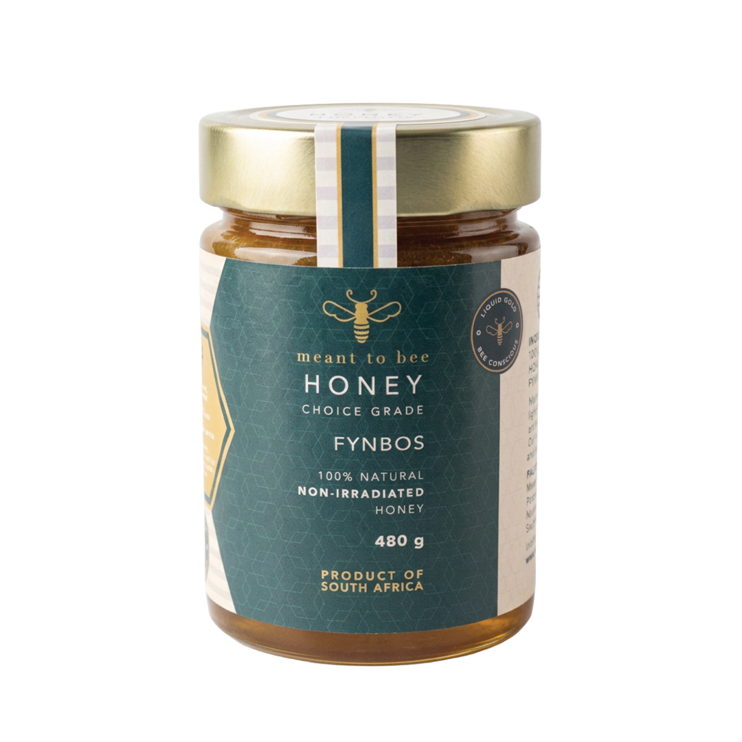 A glass jar of Meant To Bee Fynbos honey with a gold lid and deep green label.
